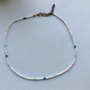 Handmade beaded necklace. Mostly white but other colors mixed in as well.